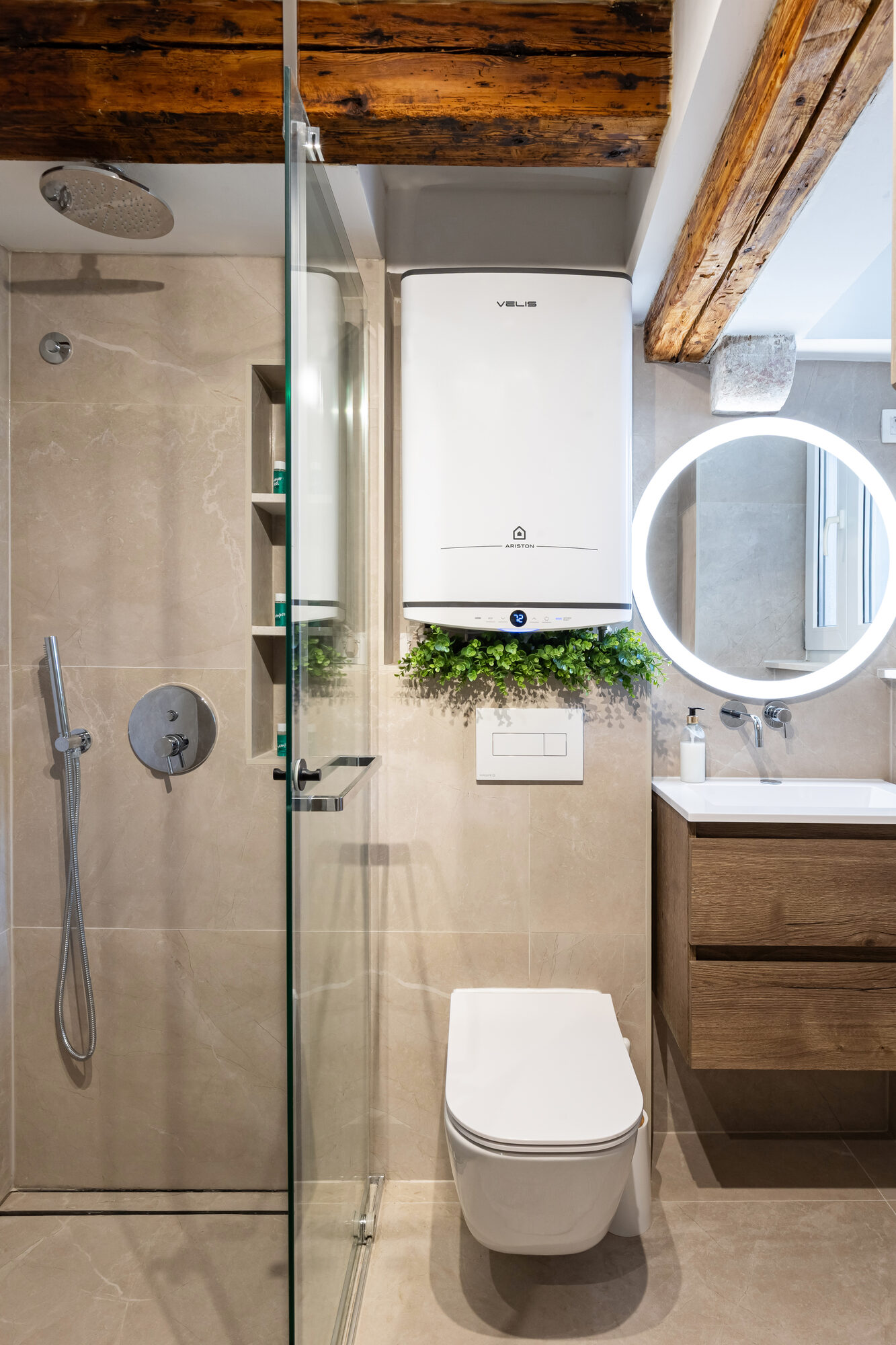 En-suite bathroom with marble walls and rain shower