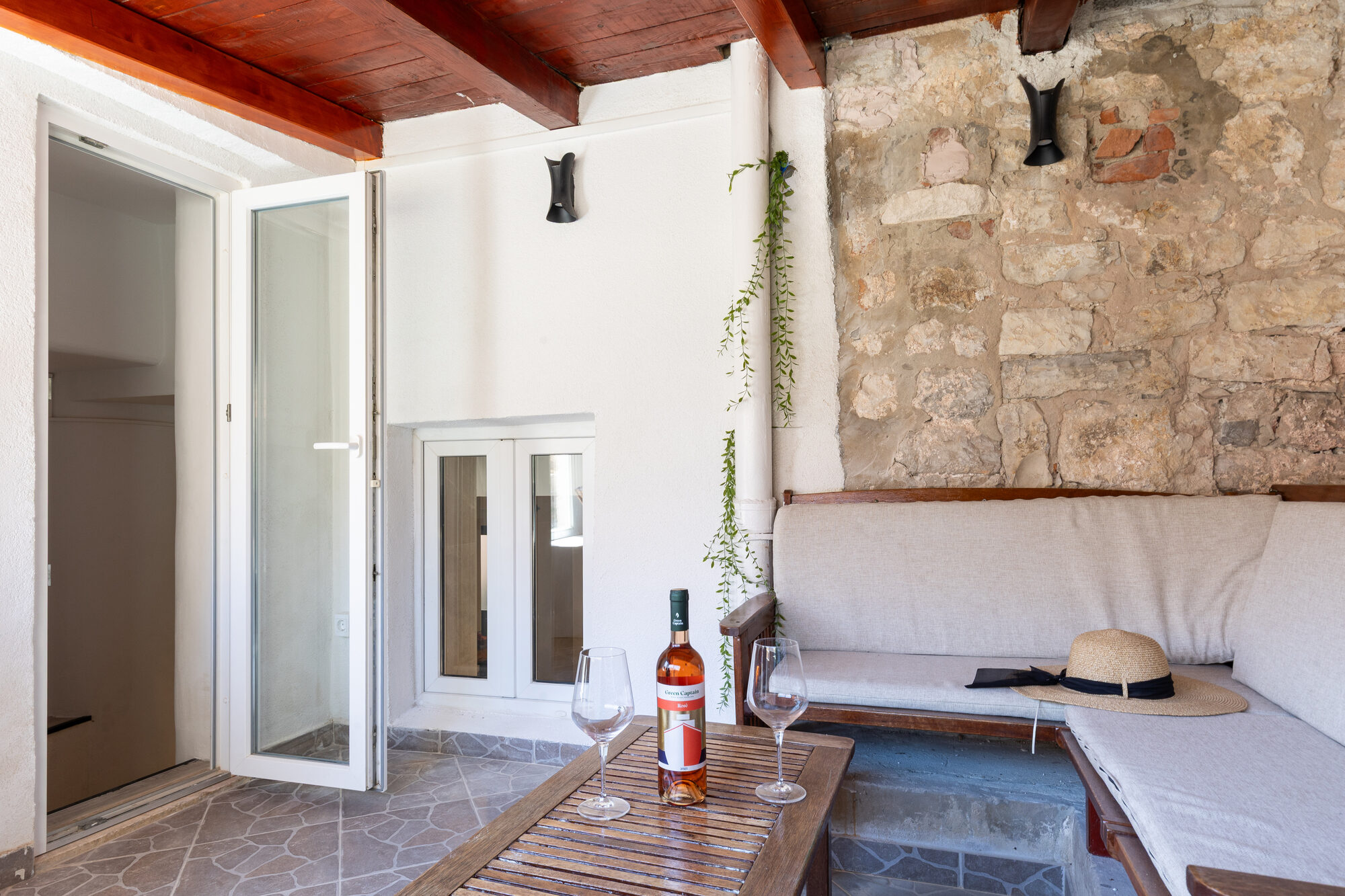 Shared terrace with wine and sun hat